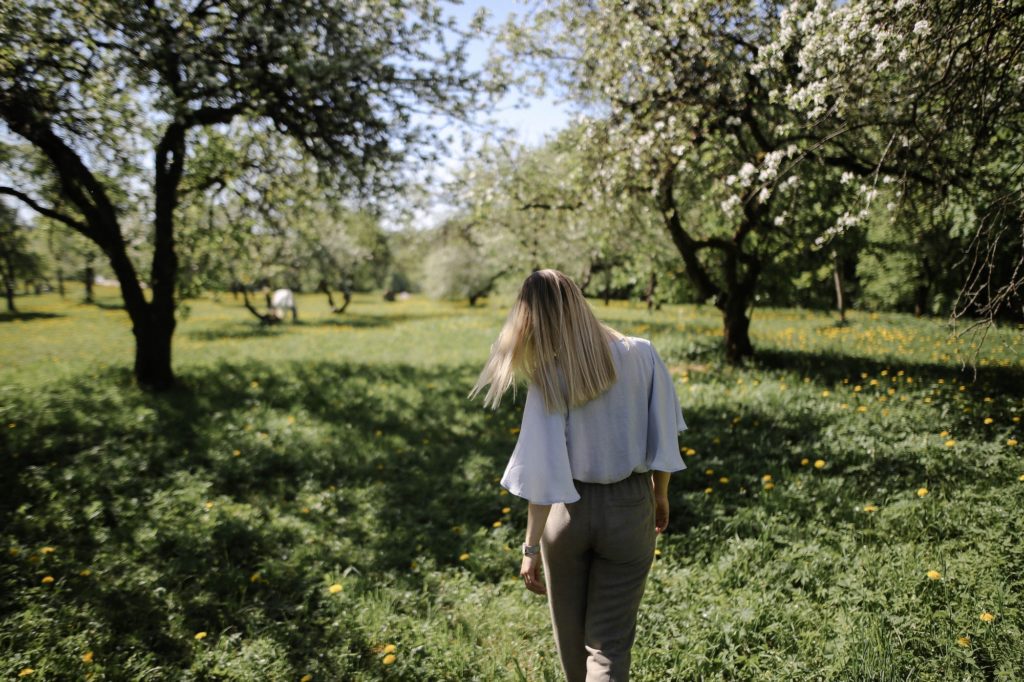 Woman walking in park on the first day of spring